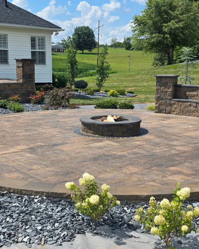 Round paver patio with a fire pit after cleaning and sealing
