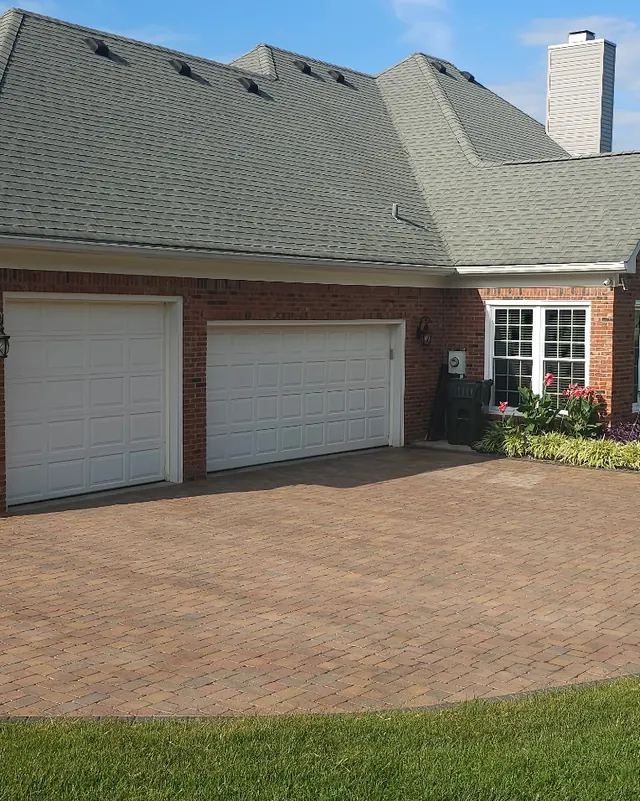 Brick home with a clean paver driveway