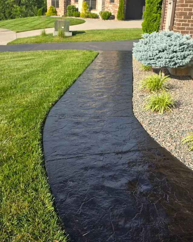 Curved stamped concrete walk after sealing