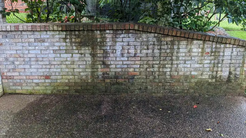Before: brick planter wall and aggregate patio