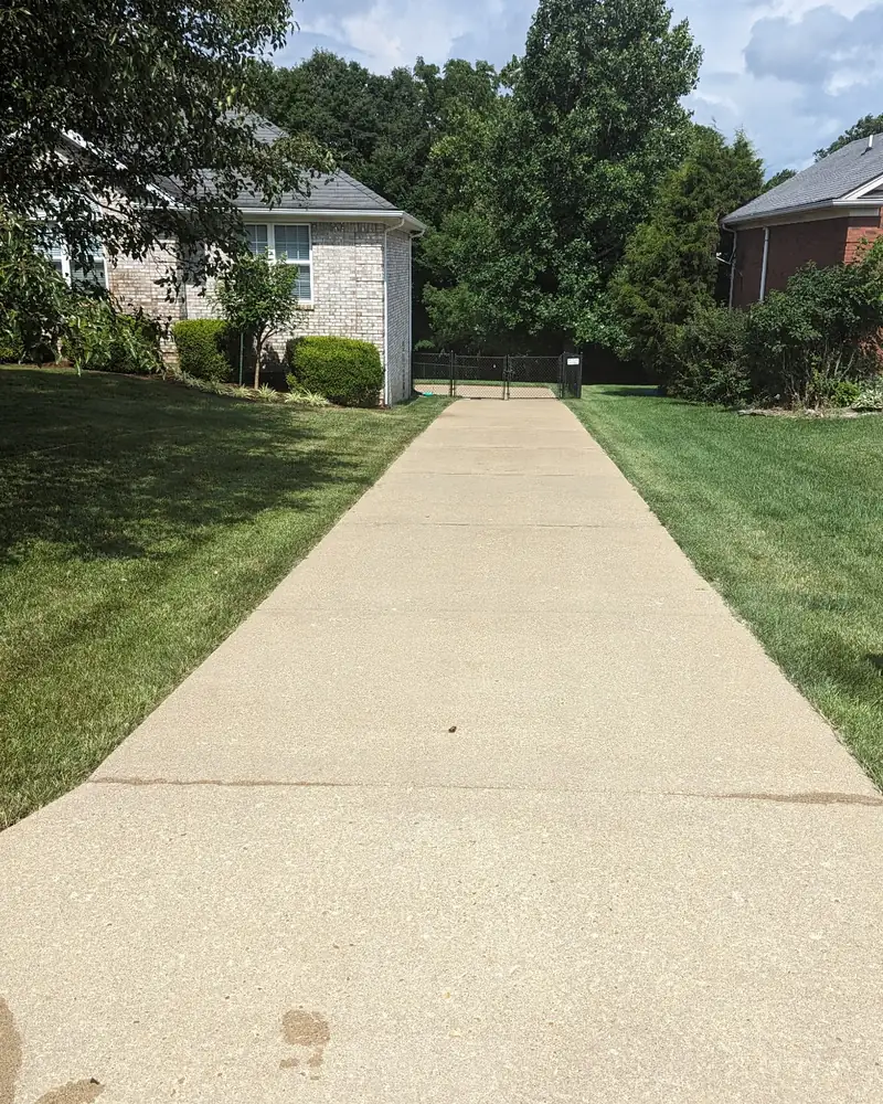 After: long concrete driveway, cleaned by Meyer Pressure Washing