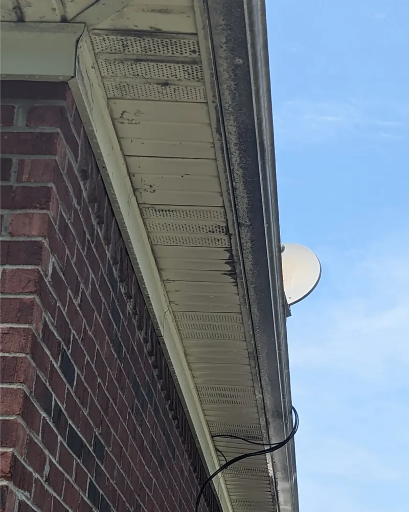 Before: gutter and soffit on a brick home