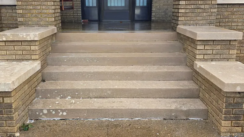 After: concrete porch steps with brick columns, cleaned by Meyer Pressure Washing