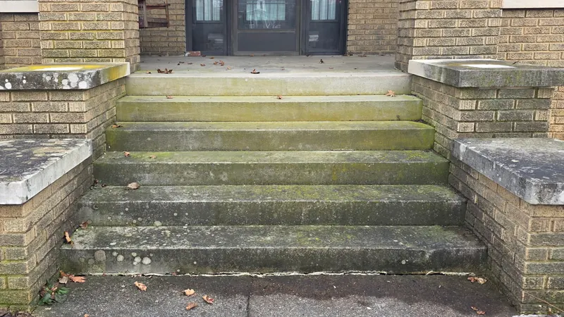 Before: concrete porch steps with brick columns