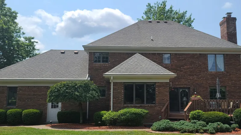 After: shingle roof on a two-story brick home, cleaned by Meyer Pressure Washing