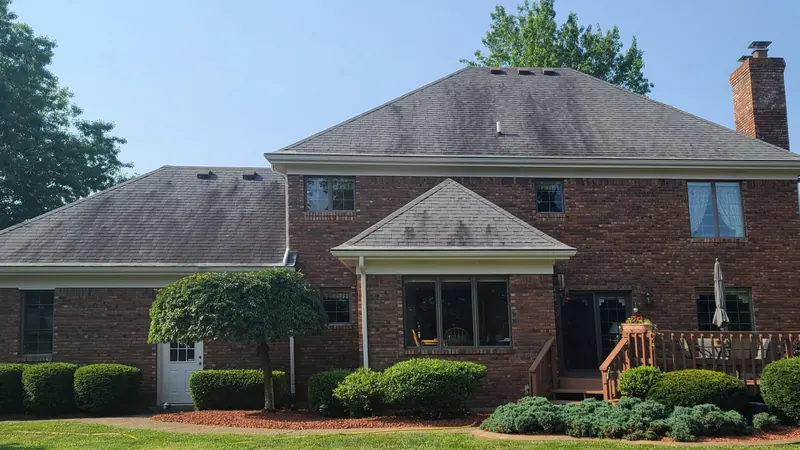 Before: shingle roof on a two-story brick home
