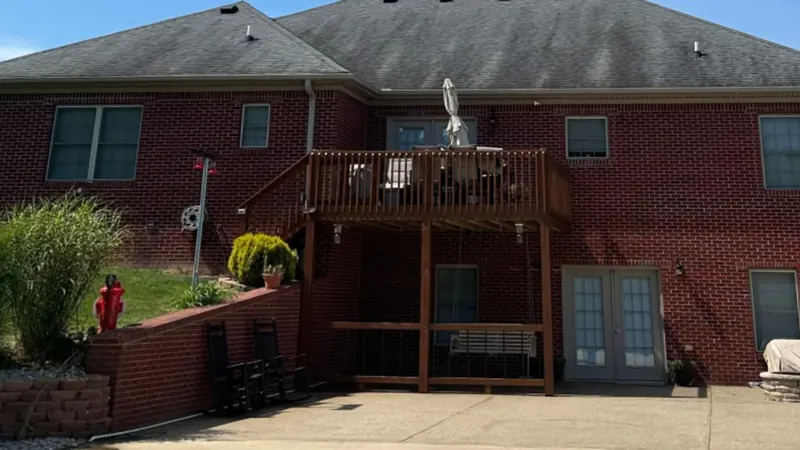 Before: rear shingle roof of a brick home