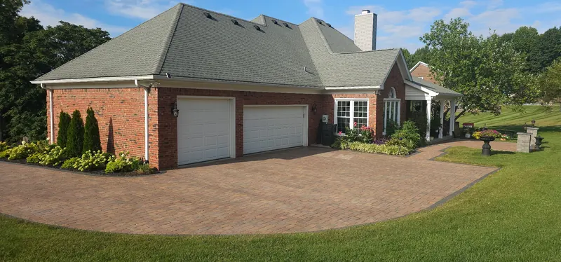 Brick home with a clean paver driveway